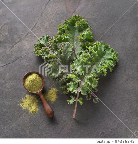 Kale salad with kale powder on graphite background Kale salad with kale powder on graphite background 94336845