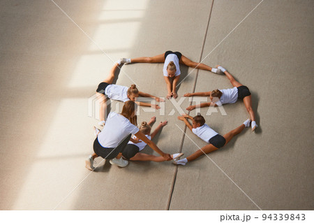 Aerial view. Female sports coach training gymnastics athletes at sports gym, indoors. Concept of sport, studying, art, education 94339843
