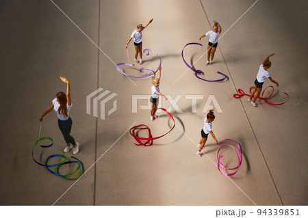 Aerial view. Female sports coach training gymnastics athletes at sports gym, indoors. Concept of sport, studying, art, education 94339851