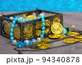 Pirate treasure chest with treasures on the beach. 94340878