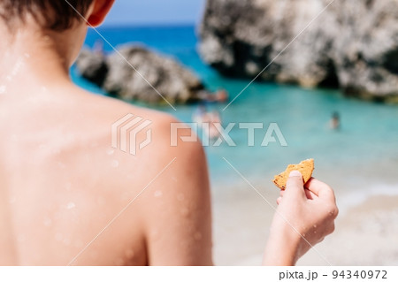 Child boy holds cake his hands and eats it. Child boy holds cake his hands and eats it. 94340972