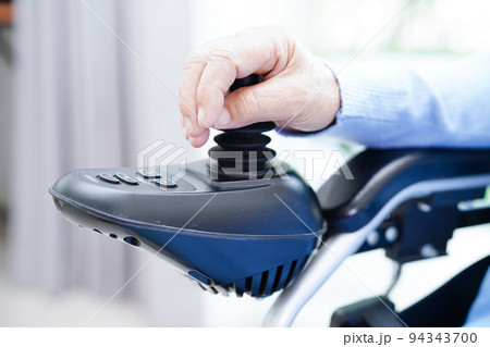 Asian elderly woman disability patient sitting on electric wheelchair in park, medical concept. Asian elderly woman disability patient sitting on electric wheelchair in park, medical concept. 94343700