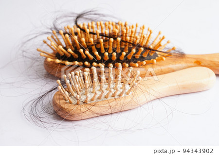 Hair loss fall with comb brush isolated on white background. 94343902