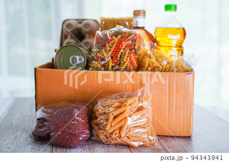 Foodstuffs in donation box for volunteer. Foodstuffs in donation box for volunteer. 94343941