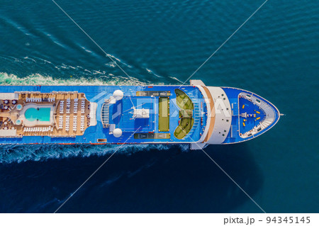 Luxury passenger liner in the bay of Kotor with travel returning after the Covid 19 pandemic Portrait of a disgruntled girl sitting at a cafe table 94345145