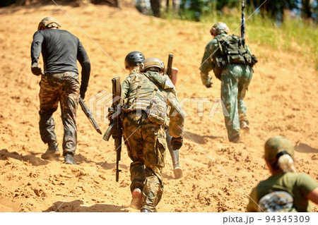 Young military soldiers during military maneuver training Young military soldiers during military maneuver training 94345309