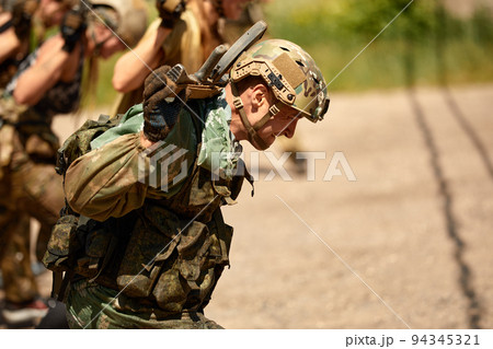 Young military soldiers during military maneuver training Young military soldiers during military maneuver training 94345321
