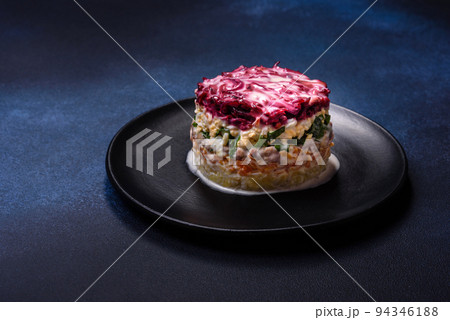 Traditional Ukrainian multilayered salad from herring, beets, potatoes, carrots and eggs 94346188