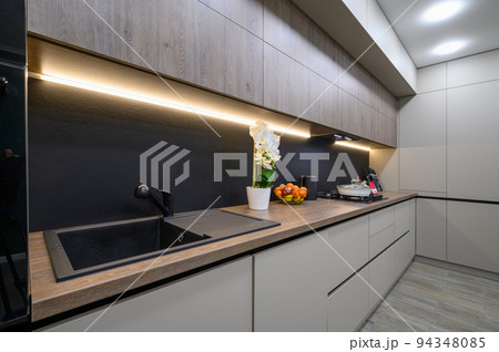 Trendy grey modern kitchen interior with minimalistic furniture Trendy grey modern kitchen interior with minimalistic furniture 94348085
