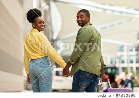 Cheerful African American Spouses Walking With Suitcase Posing At Airport 94350899