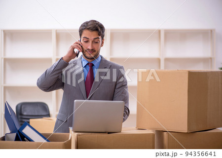 Young male employee in office relocation concept Young male employee in office relocation concept 94356641