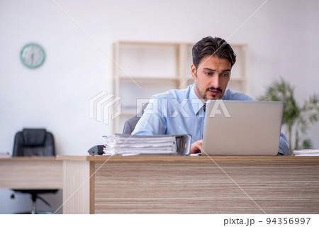 Young male employee working in the office 94356997