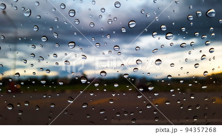Rain water drops cover on the glass with blur background 94357268