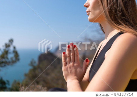 Young woman with long hair, fitness instructor in Sportswear Leggings and Tops, stretching before pilates, on a yoga mat near the sea on a sunny day, female fitness yoga routine concept Young woman with long hair, fitness instructor in Sportswear Leggings and Tops, stretching before pilates, on a yoga mat near the sea on a sunny day, female fitness yoga routine concept 94357714