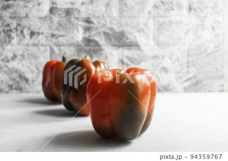 Colorful vegetables, yellow, green and red bell peppers on gray wall background Colorful vegetables, yellow, green and red bell peppers on gray wall background 94359767