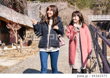 茅葺民家を観光する二人の女性《撮影協力：西湖いやしの里根場様》 94362475