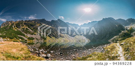Tatra National Park, Poland. Lake Czarny Staw Under Rysy And Summer Mountains Landscape. Beautiful Nature, Scenic Panoramic View Of Five Lakes Valley. UNESCO World Heritage Site. Panorama Tatra National Park, Poland. Lake Czarny Staw Under Rysy And Summer Mountains Landscape. Beautiful Nature, Scenic Panoramic View Of Five Lakes Valley. UNESCO World Heritage Site. Panorama 94369228