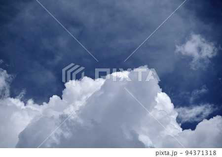 White puffy cumulus clouds on summer blue sky White puffy cumulus clouds on summer blue sky 94371318