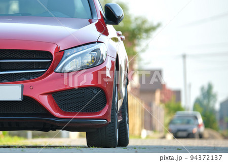 Close up of a car parked on city street side. Urban traffic concept Close up of a car parked on city street side. Urban traffic concept 94372137