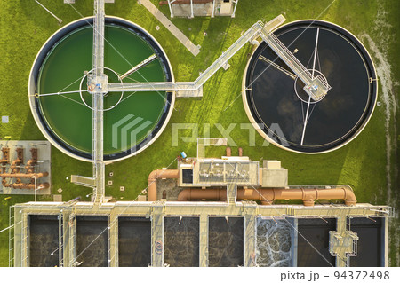 Aerial view of modern water cleaning facility at urban wastewater treatment plant. Purification process of removing undesirable chemicals, suspended solids and gases from contaminated liquid 94372498