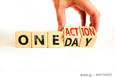 One day and action symbol. Concept words One day and One action on wooden cubes. Businessman hand. Beautiful white table white background. Business One day and action concept. Copy space. 94374455