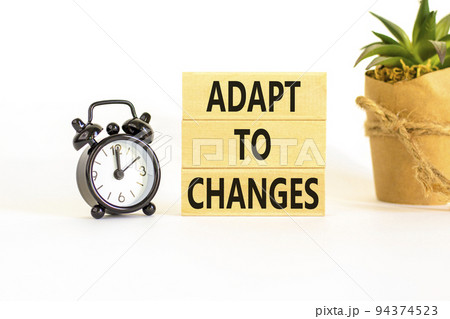 Adapt to changes symbol. Concept words Adapt to changes on wooden blocks. Black alarm clock. Beautiful white table white background. Business and Adapt to changes quote concept. Copy space. Adapt to changes symbol. Concept words Adapt to changes on wooden blocks. Black alarm clock. Beautiful white table white background. Business and Adapt to changes quote concept. Copy space. 94374523