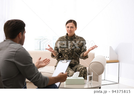 Psychotherapist working with female military officer in office Psychotherapist working with female military officer in office 94375815