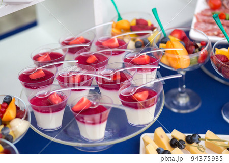 Fruit desserts on the table for a festive event or dinner Fruit desserts on the table for a festive event or dinner 94375935