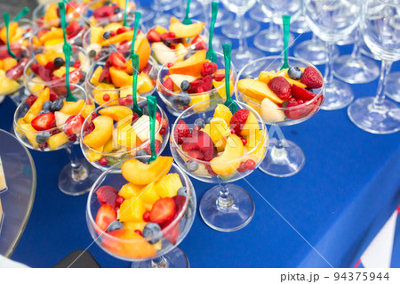 Fruit desserts on the table for a festive event or dinner Fruit desserts on the table for a festive event or dinner 94375944