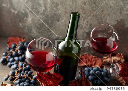 Red wine and blue grapes. 94386036