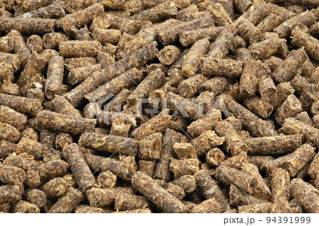 Animal feed. Sunflower granulated feed  on white background, close-up. 94391999