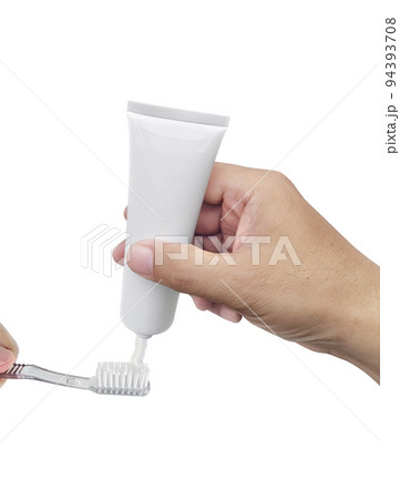 The guy squeezes toothpaste on the toothbrush The guy squeezes toothpaste on the toothbrush 94393708