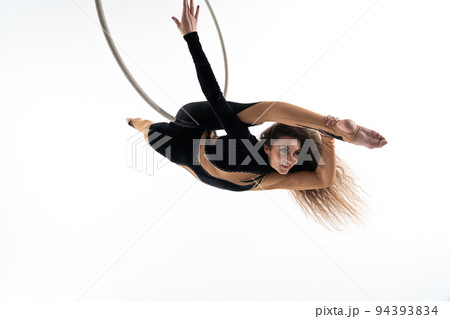 Slim and flexible woman, circus artist In aerial hoop isolated On White Background. Concept of desire, will and potential Slim and flexible woman, circus artist In aerial hoop isolated On White Background. Concept of desire, will and potential 94393834