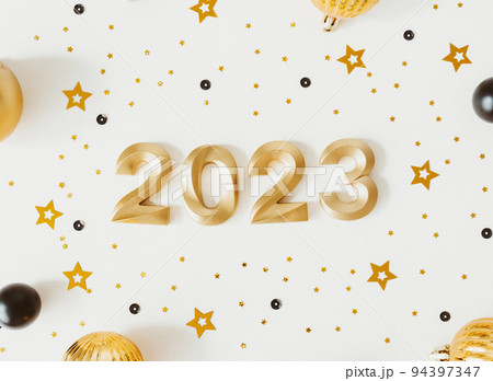 Greeting card - happy new year with numbers 2023, gold glitter and christmas balls on white background. Greeting card - happy new year with numbers 2023, gold glitter and christmas balls on white background. 94397347