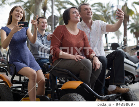 family of tourists enjoy a walk on the bike carriage family of tourists enjoy a walk on the bike carriage 94398697