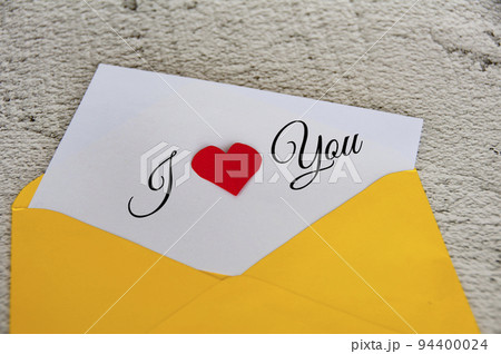 I love you text on notepad in yellow envelope. Romance and relationship concept 94400024