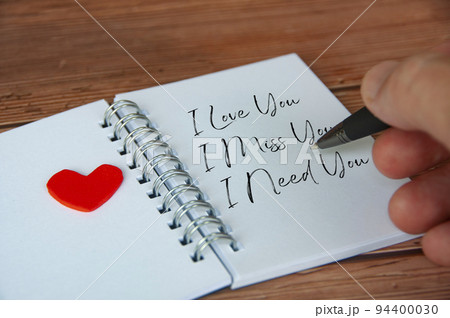 I love you text on notepad with wooden cover and pen background. Romance and relationship concept I love you text on notepad with wooden cover and pen background. Romance and relationship concept 94400030