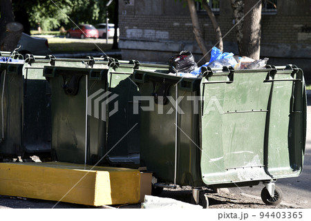 Garbage cans in the urban area and a landfill. Plastic garbage containers in the village. Garbage cans in the urban area and a landfill. Plastic garbage containers in the village. 94403365