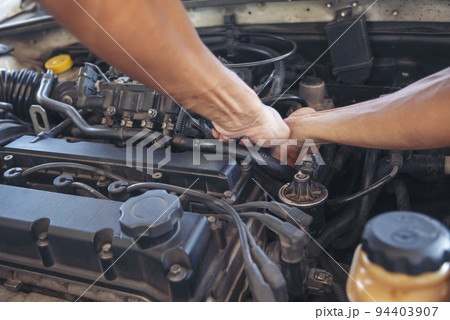 Close up Man hands fixing Car machinery vehicle mechanical service. Mechanic man hands repairing car auto repair shop. open vehicle hood checking up auto mobile. Vehicle Car maintenance engineer. Close up Man hands fixing Car machinery vehicle mechanical service. Mechanic man hands repairing car auto repair shop. open vehicle hood checking up auto mobile. Vehicle Car maintenance engineer. 94403907