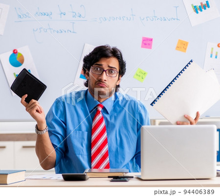 Young male financial manager working in the office Young male financial manager working in the office 94406389
