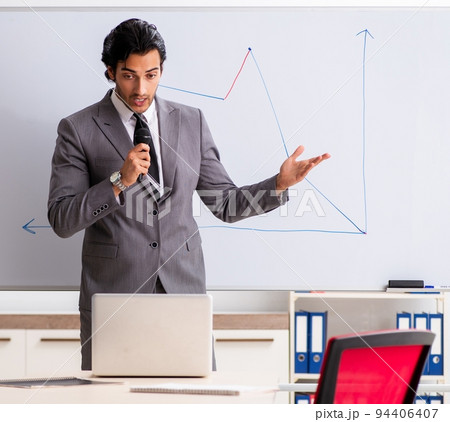 Young handsome businessman in front of whiteboard 94406407