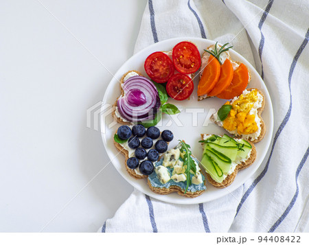 Rainbow sandwiches heart shape on white table 94408422