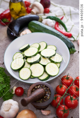 sliced zucchini in a plate and vegetables at domestic kitchen 94409536