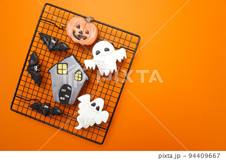 Gingerbread cookies for Halloween celebration are on an orange background 94409667