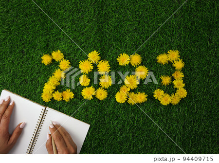 The numbers 2023 are laid out on the green lawn 94409715
