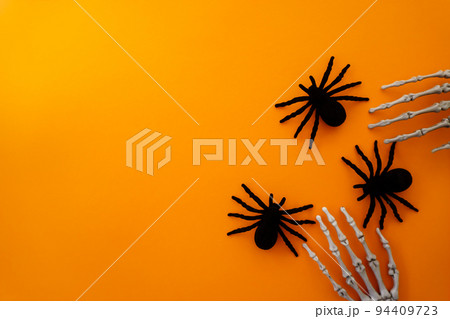 Halloween greeting card with spiders and a skeleton 94409723