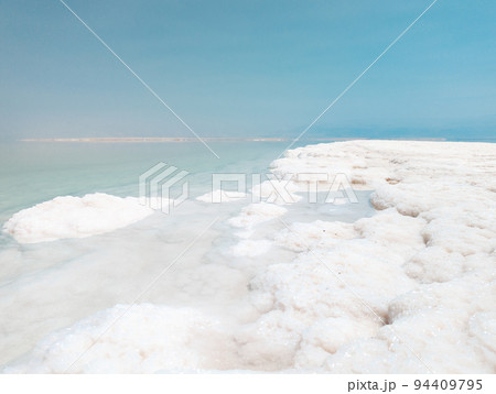 Landscape view on Dead Sea salt crystals formations, clear cyan green water at Ein Bokek beach, Israel Landscape view on Dead Sea salt crystals formations, clear cyan green water at Ein Bokek beach, Israel 94409795