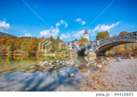 Astonishing view of Church of St. John the Baptist on Bohinj Lake . Astonishing view of Church of St. John the Baptist on Bohinj Lake . 94410605