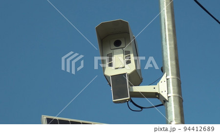 Camera for monitoring vehicle violations on the road. Photo camera on a pole. Camera for monitoring vehicle violations on the road. Photo camera on a pole. 94412689