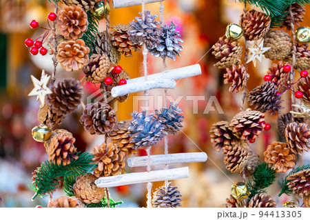 Colorful handmade Christmas decorations hanging on traditional winter fair Colorful handmade Christmas decorations hanging on traditional winter fair 94413305